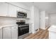Bright kitchen features stainless steel appliances, white cabinets, and ample counter space at 109 Magnolia Ave, Seffner, FL 33584
