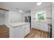 Bright kitchen featuring a kitchen island, stainless steel appliances, and wood floors at 109 Magnolia Ave, Seffner, FL 33584