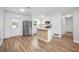 Modern open concept with eat in kitchen, new appliance and wood floor at 109 Magnolia Ave, Seffner, FL 33584