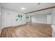 Open-concept living room boasts wood-look floors and lots of natural light at 109 Magnolia Ave, Seffner, FL 33584