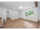 Open living area filled with natural light, showcasing the beautiful wood-look flooring at 109 Magnolia Ave, Seffner, FL 33584