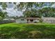 Lush backyard with a small patio, providing a private outdoor space for relaxation and enjoyment at 117 Connie Ave, Tampa, FL 33613