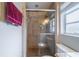 This bathroom showcases a shower with a glass door and tiled walls at 117 Connie Ave, Tampa, FL 33613