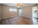 Bedroom with wood floors, a ceiling fan, natural light, and access to an en-suite bathroom at 117 Connie Ave, Tampa, FL 33613