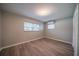 This bedroom has wood floors, natural light, and neutral walls at 117 Connie Ave, Tampa, FL 33613