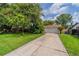 Charming home with a well-manicured lawn and a long driveway leading to a two-car garage at 117 Connie Ave, Tampa, FL 33613