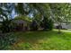 Charming home with a well-maintained front yard featuring mature landscaping and a tidy lawn at 117 Connie Ave, Tampa, FL 33613