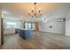 Open kitchen and living area featuring an island with quartz countertops and modern appliances at 117 Connie Ave, Tampa, FL 33613
