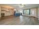 Open-concept kitchen and living space featuring a large island, wood floors, and stainless steel appliances at 117 Connie Ave, Tampa, FL 33613