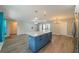 Bright, open kitchen features a large island with quartz countertops and modern pendant lighting at 117 Connie Ave, Tampa, FL 33613