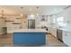 Modern kitchen featuring an island with quartz countertop, white cabinets, and stainless steel appliances at 117 Connie Ave, Tampa, FL 33613