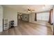 Living room featuring wood-look floors, ceiling fans, and large windows for natural light at 117 Connie Ave, Tampa, FL 33613