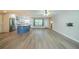 Spacious open-concept living and kitchen area boasts sleek wood floors and modern lighting at 117 Connie Ave, Tampa, FL 33613