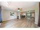 Open living space featuring wood floors, ceiling fans and an open floor plan with combined kitchen and dining areas at 117 Connie Ave, Tampa, FL 33613