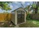 Durable backyard storage shed with double doors, windows, and neutral colors, adding functionality at 117 Connie Ave, Tampa, FL 33613