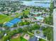 Aerial view of neighborhood amenities including pools, playgrounds, tennis courts, and scenic ponds in a lush community at 11806 Holly Crest Ln, Riverview, FL 33569
