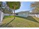 Lush backyard offering ample space, privacy fencing, and mature palm trees for shade and beauty at 11806 Holly Crest Ln, Riverview, FL 33569