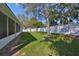 Expansive backyard featuring lush green grass, mature trees, and a white vinyl fence for privacy at 11806 Holly Crest Ln, Riverview, FL 33569