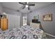 Comfortable bedroom with gray walls, wood-look flooring, closet, and a ceiling fan at 11806 Holly Crest Ln, Riverview, FL 33569