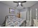 Bedroom featuring a patterned bedspread, wood-look flooring, and natural light at 11806 Holly Crest Ln, Riverview, FL 33569