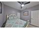 Bedroom features gray walls, a ceiling fan, and art adorning the walls at 11806 Holly Crest Ln, Riverview, FL 33569