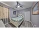 Cozy bedroom features a ceiling fan, wood floors, and a decorative white headboard at 11806 Holly Crest Ln, Riverview, FL 33569