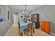 Dining room featuring tile flooring, a chandelier, and a decorative china cabinet at 11806 Holly Crest Ln, Riverview, FL 33569