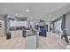 Open floor plan with kitchen featuring white cabinets, granite counters, and black appliances at 11806 Holly Crest Ln, Riverview, FL 33569