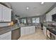 Open kitchen showcases white cabinets, modern appliances, granite countertops, and a breakfast nook at 11806 Holly Crest Ln, Riverview, FL 33569