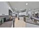 Bright kitchen featuring white cabinets, tile floors, granite countertops, and black appliances at 11806 Holly Crest Ln, Riverview, FL 33569