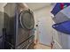 Convenient laundry room featuring a stacked washer and dryer, maximizing space and efficiency at 11806 Holly Crest Ln, Riverview, FL 33569