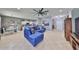 Open-concept living space with tile flooring, modern decor, and a comfortable blue sectional sofa at 11806 Holly Crest Ln, Riverview, FL 33569