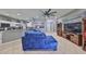 Spacious living room with tile floors, modern furnishings, ceiling fan, and view of kitchen at 11806 Holly Crest Ln, Riverview, FL 33569