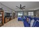 Comfortable living room featuring a large ceiling fan, neutral decor and access to the outdoor patio at 11806 Holly Crest Ln, Riverview, FL 33569