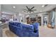 Cozy living room featuring a large ceiling fan, tile flooring and a comfortable blue sectional sofa at 11806 Holly Crest Ln, Riverview, FL 33569
