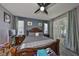 Main bedroom features wood-look floors, a ceiling fan, and generous natural light at 11806 Holly Crest Ln, Riverview, FL 33569
