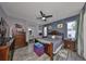 Main bedroom boasts wood-look floors, a ceiling fan, and plenty of space for a sitting area at 11806 Holly Crest Ln, Riverview, FL 33569
