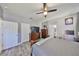 Main bedroom offers wood-look floors, a ceiling fan, and access to the main bathroom at 11806 Holly Crest Ln, Riverview, FL 33569