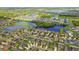 Wide aerial shot of a community highlighting picturesque lakes and green spaces at 11837 Thicket Wood Dr, Riverview, FL 33579
