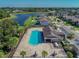 A high angle aerial of community pool in a neighborhood setting with a lake nearby at 11837 Thicket Wood Dr, Riverview, FL 33579