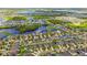 Scenic aerial view of a thriving community featuring lakes, greenery, and well-spaced homes at 11837 Thicket Wood Dr, Riverview, FL 33579