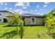 Exterior view of home, showing the backyard with lush green grass and landscaping at 11837 Thicket Wood Dr, Riverview, FL 33579