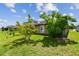 Home exterior featuring a green backyard with lush landscaping at 11837 Thicket Wood Dr, Riverview, FL 33579