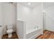 This bathroom has a garden tub and a separate shower, with wood-look flooring at 11837 Thicket Wood Dr, Riverview, FL 33579