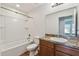 The bathroom features a shower-tub combo, a granite countertop, and wood cabinets at 11837 Thicket Wood Dr, Riverview, FL 33579