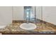 The bathroom features a single sink vanity with granite countertops and wood cabinets at 11837 Thicket Wood Dr, Riverview, FL 33579