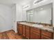 The bathroom features double sinks, granite countertops, wood cabinets, and a large mirror at 11837 Thicket Wood Dr, Riverview, FL 33579