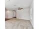 Bedroom with neutral carpet and adjacent hallway with wood floors at 11837 Thicket Wood Dr, Riverview, FL 33579