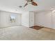 Large bedroom with neutral carpet, ceiling fan, and a window providing natural light at 11837 Thicket Wood Dr, Riverview, FL 33579