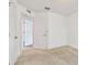 Bright bedroom featuring plush carpet, white trim, and multiple doorways at 11837 Thicket Wood Dr, Riverview, FL 33579